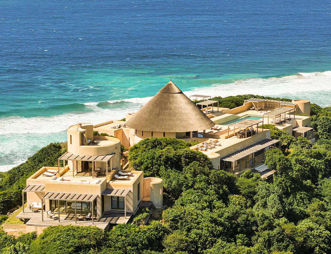 stunning aerial shot of matalai house on a sunny day with an azure ocean backdrop