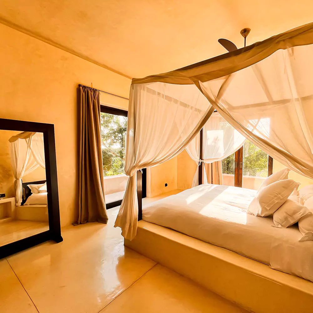 warm interior and four poster bed of a luxury suite at matalai house