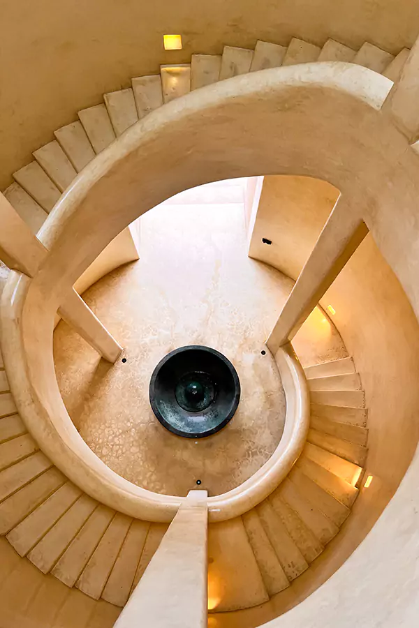 a grand spiral staircase at the heart of matalai villa